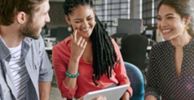 three students smiling in conversation